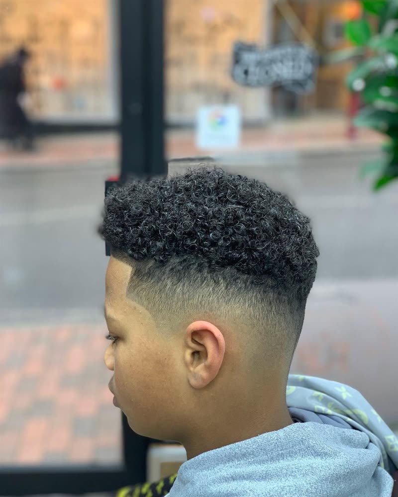 Curly top with a drop fade, cut at Royal Barbers Tunbridge Wells