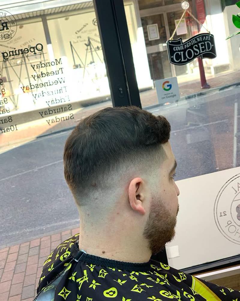 Mid fade with a beard, side profile