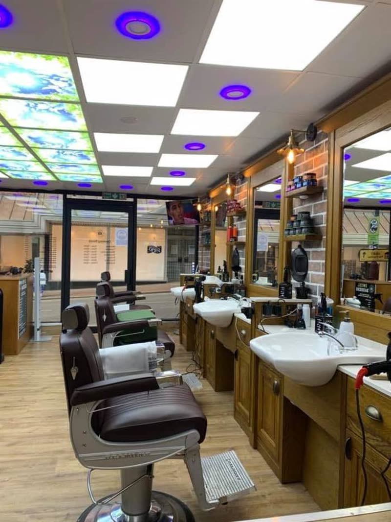 Inside Royal Barbers on Grove Hill Road, Tunbridge Wells: oak stations, barber chairs and mirrors
