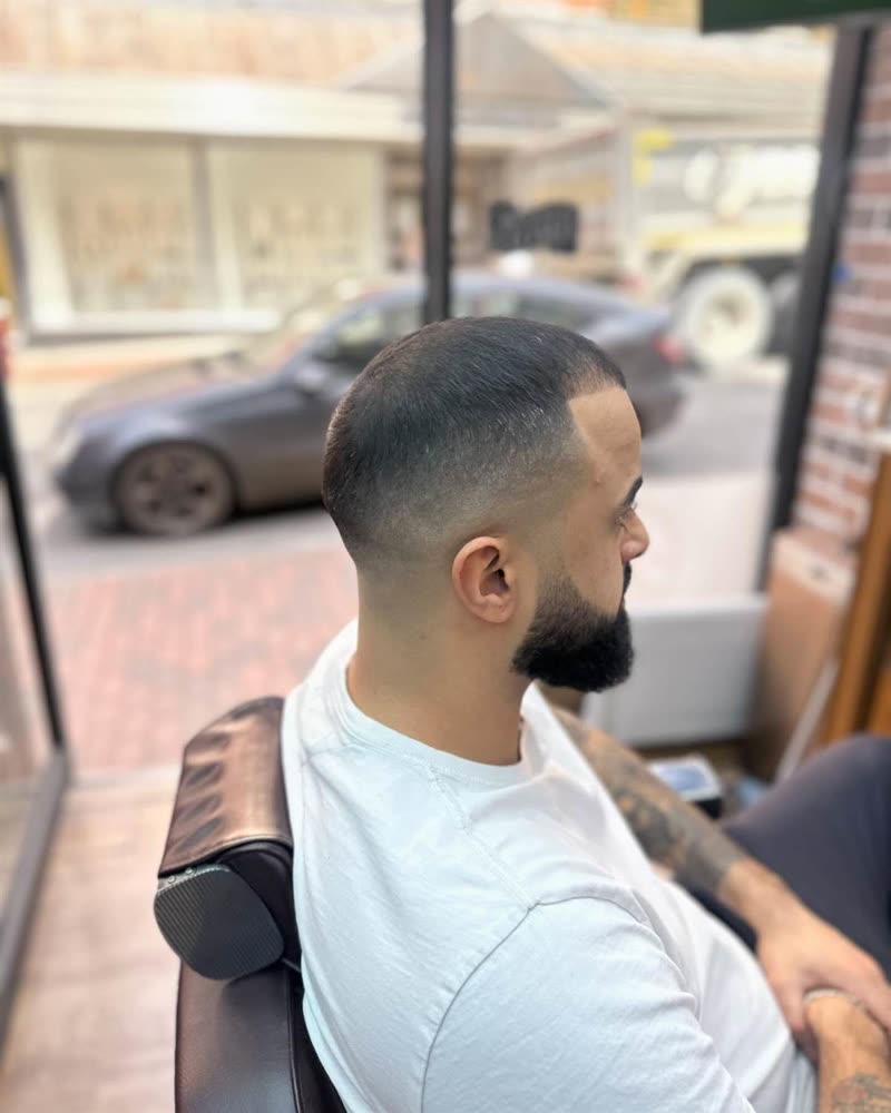 Skin fade with a full beard shape up at Royal Barbers