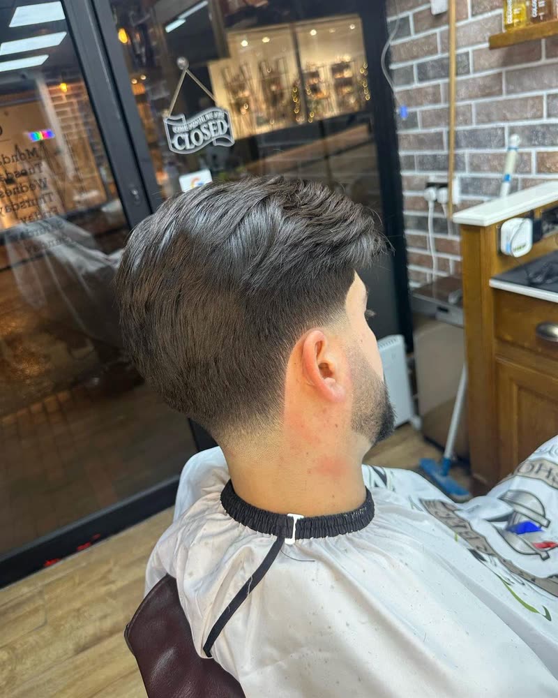 Slick back with a fade, side profile